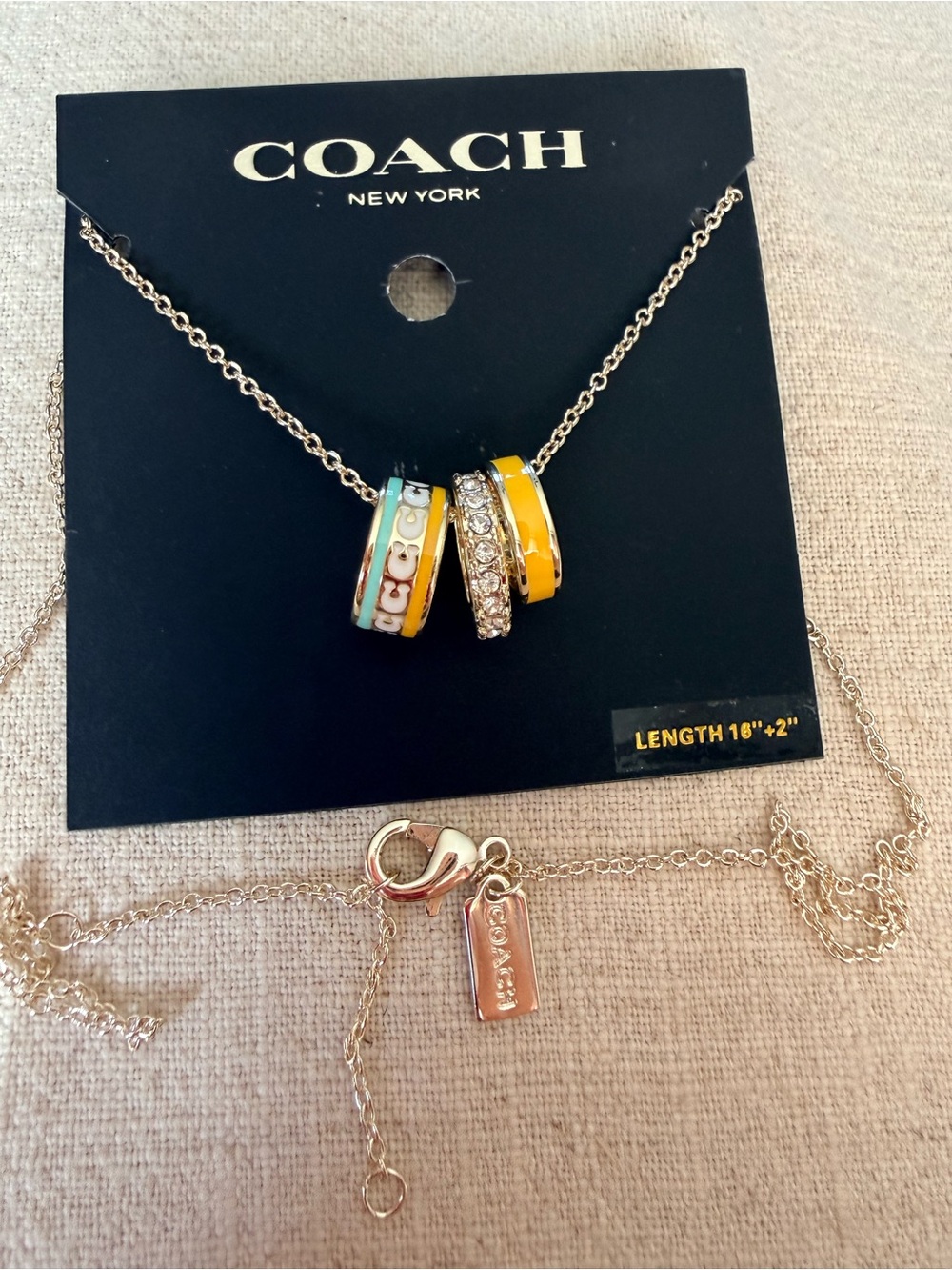 COACH Silver Tone Pendant Necklace with Yellow and Turquoise Enamel Rings